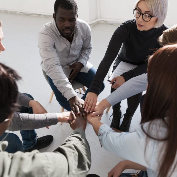 group-rehab-patients-putting-their-hands-together